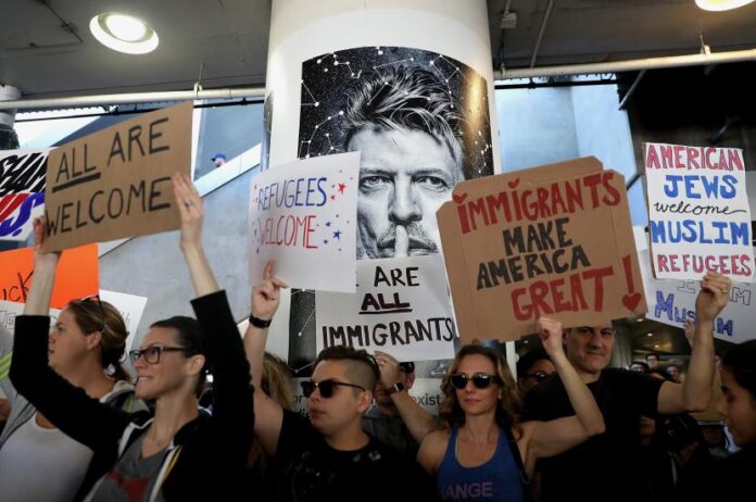 Protesters hold signs